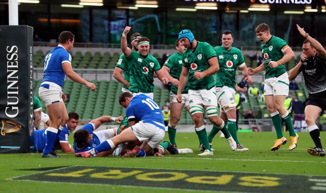 Ireland celebrate as CJ Stander, hidden, goes over for their first try