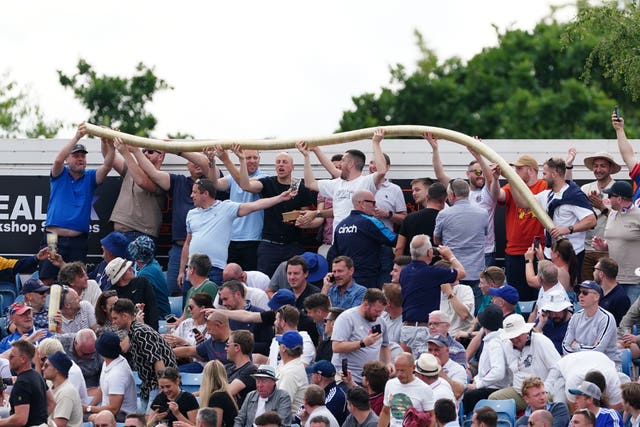 Fans make a beer snake in the Western Terrace