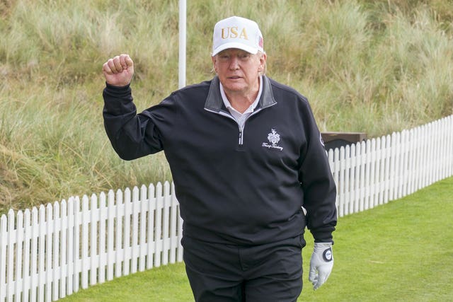 US President Donald Trump walks on to the first tee for the official opening of the New Course, the second championship course at Trump International Golf Links, on the Menie Estate in Balmedie, Aberdeenshire