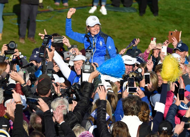 Europe Solheim Cup captain Catriona Matthew is held aloft on the 18th green
