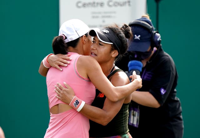 Heather Watson, right, hugs China’s Zhang Shuai after her retirement at Birmingham