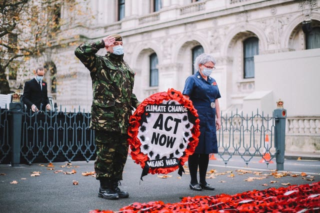 Extinction Rebellion campaigner Donald Bell observed a two-minute silence before hanging a wreath of poppies on the Cenotaph