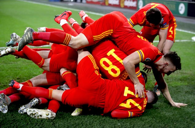 Aaron Ramsey, obscured, celebrates scoring