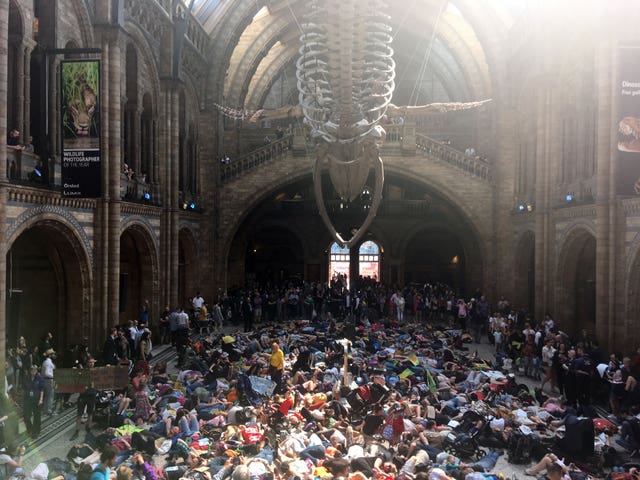 Extinction Rebellion protesters lying down inside the Natural History Museum in London