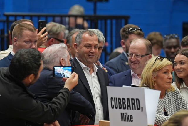 Noel Thomas standing amongst election count staff