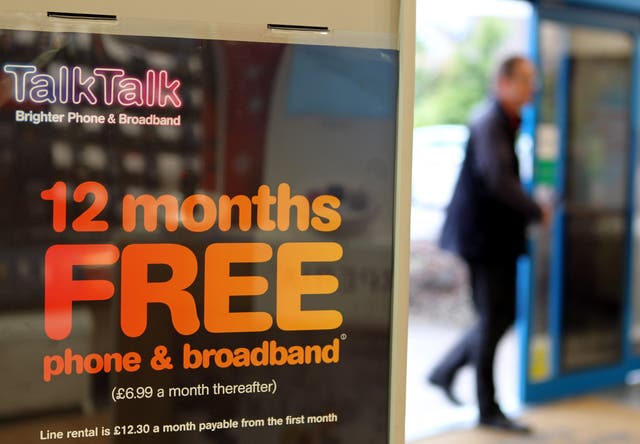 Man walking into a building, with a phone saying '12 months free' at the left hand side of the screen