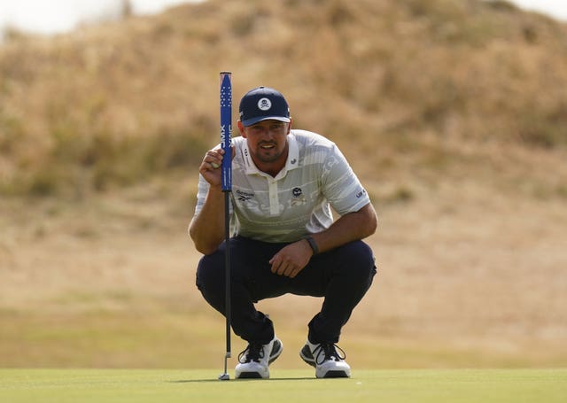 Bryson DeChambeau sizes up a putt on the third green