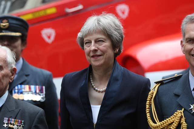 Prime Minister Theresa May stands with members of the RAF in front of a replica of a Hawk jet (Jonathan Brady/PA)