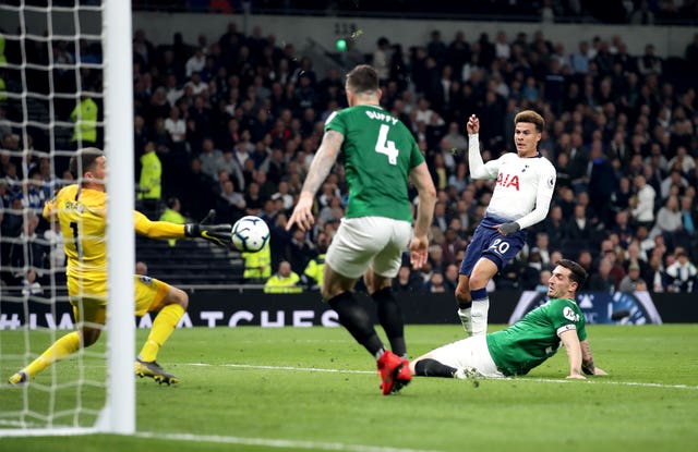 Mat Ryan, left, saves from Dele Alli, second right
