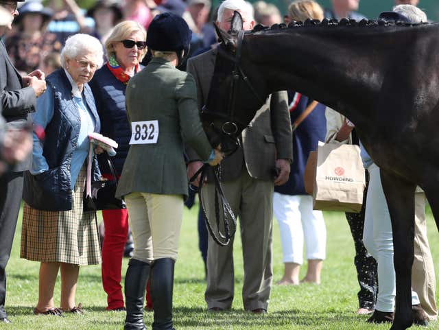 The Queen looking at one of the horses (Steve Parsons/PA)