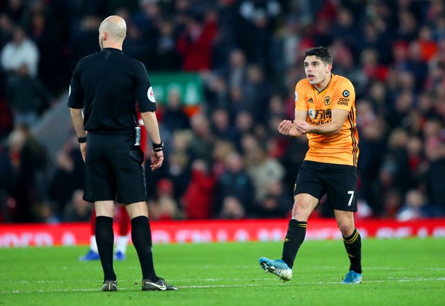 Pedro Neto (right) appeals to referee Anthony Taylor as VAR disallows his goal for Wolves