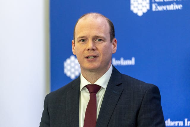 Communities Minister Gordon Lyons speaking during a press conference