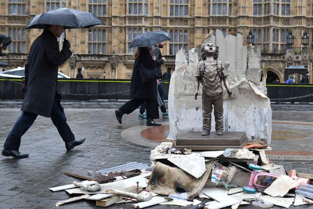 A life-size statue of a child placed by Save the Children next to the Houses of Parliament (Dominic Lipinski/PA)