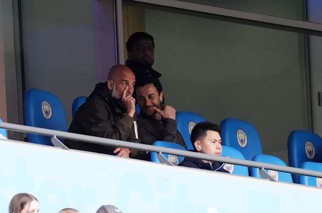 Manchester City manager Pep Guardiola sits in the stands during a game