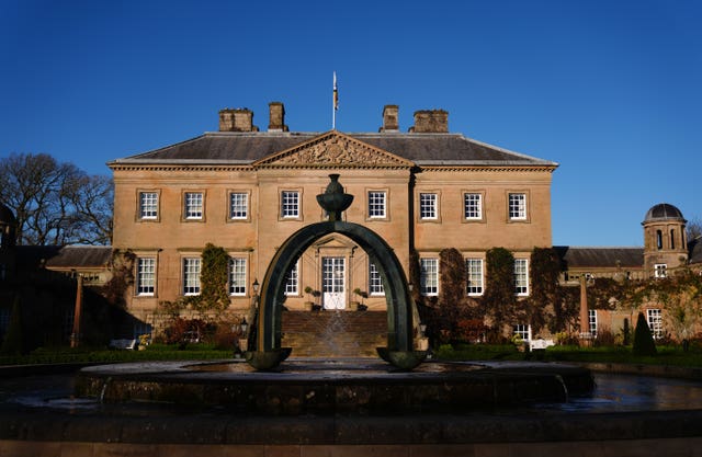 View of the front of Dumfries House, under a blue sky