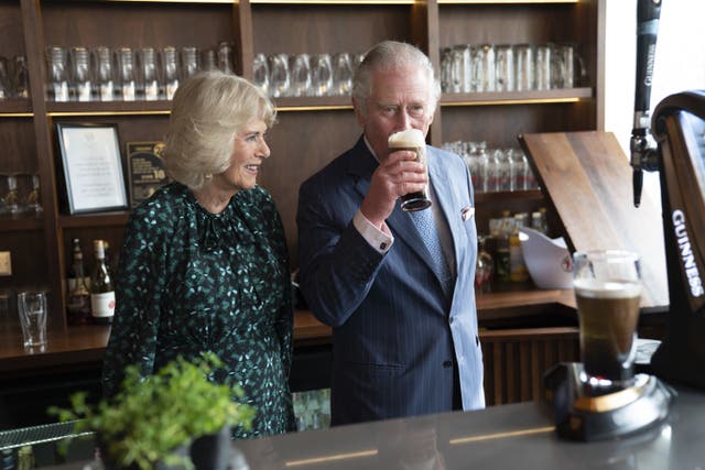 Charles enjoys a taste of the pint he poured