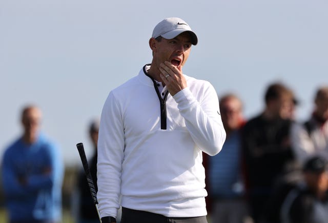 Rory McIlroy holds his face