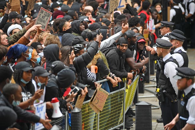 Protesters face police at the entrance to Downing Street