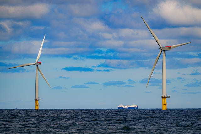 A ship passing an offshore wind farm