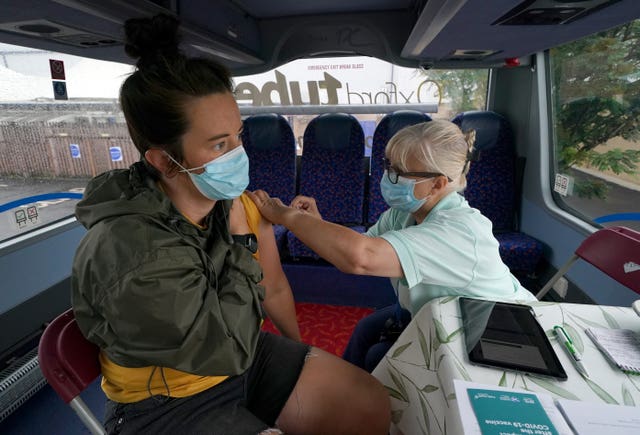 Man being vaccinated on a vaccine bus