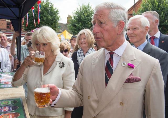 Charles and Camilla drinking Rutland bitter during their visit to the market town of Oakham in Rutland in 2014