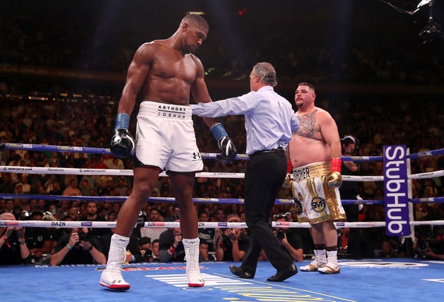 Referee Mike Griffin, centre, stops the fight