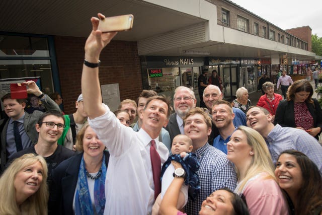 Conservative Party leadership candidate Jeremy Hunt takes a selfie with supporters during a visit to Chelmsford town centre in Essex