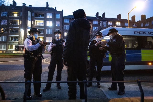 Female police officers and special constables talk to a suspect