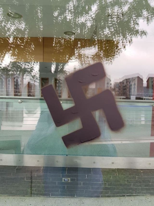 A swastika spray painted on a window of the Riverfront Theatre in Newport
