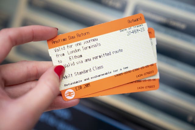 A general view of a person holding train tickets