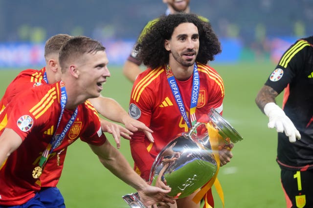 Spain’s Marc Cucurella celebrates with the trophy after winning Euro 2024