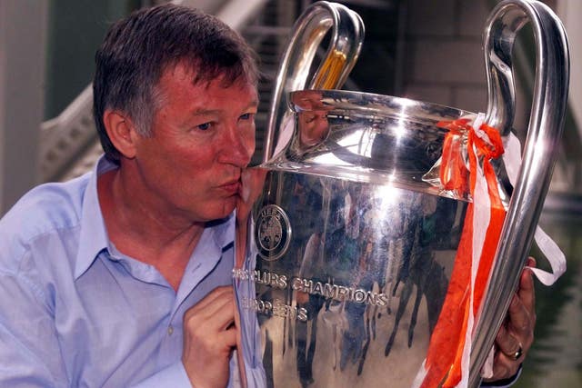 Sir Alex Ferguson celebrates with the Champions League trophy in 1999