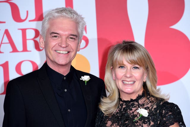 Phillip Schofield and Stephanie Lowe attend (Ian West/PA)