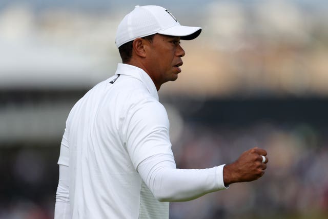 Tiger Woods celebrates his birdie on the opening hole