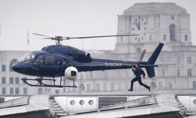 The actor films a scene as he runs along Blackfriars Bridge in London (Victoria Jones/PA)