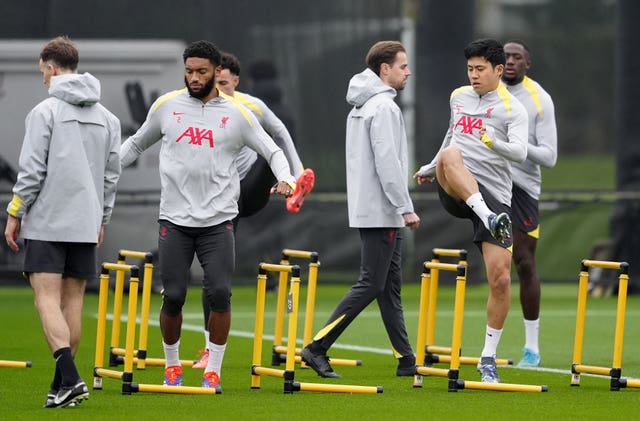 Liverpool’s Wataru Endo and Joe Gomez step over hurdles during a training session