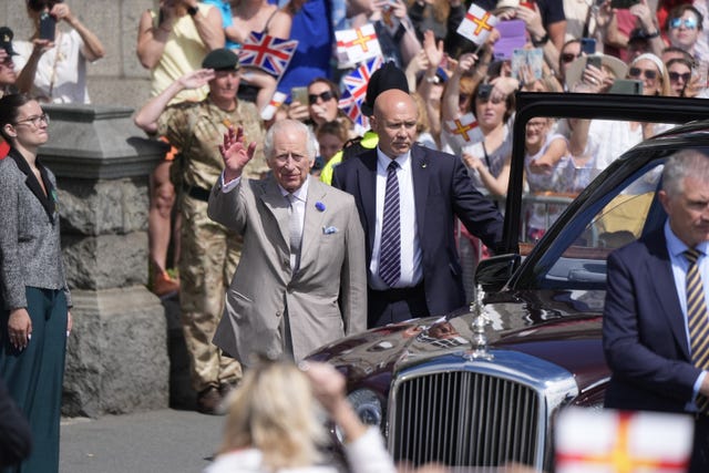 The King waves to crowds at St Peter Port