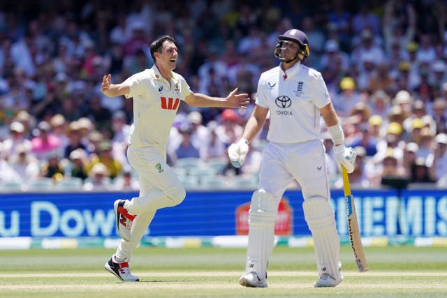 Australia captain Pat Cummins, left, celebrates taking the wicket of England's Joe Root, right, in Adelaide