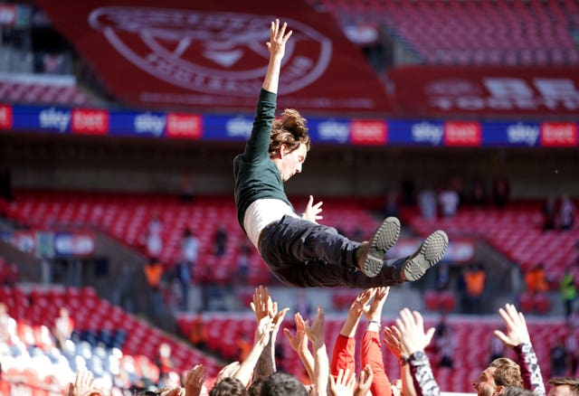 Brentford manager Thomas Frank is tossed into the air by his players