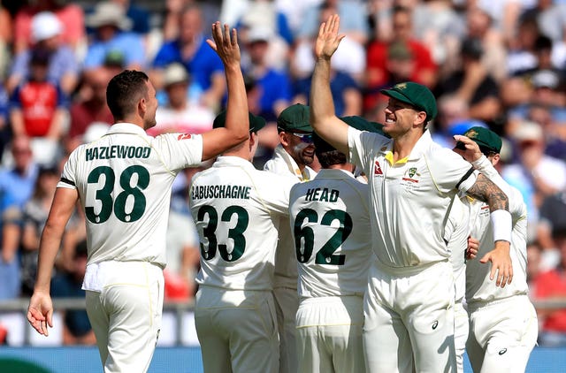 Australia’s Josh Hazlewood (left) celebrates taking the wicket of England’s Joe Root