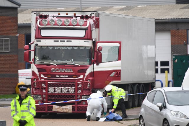 Police and forensic officers examine the lorry at the Waterglade Industrial Park in Grays, Essex, (Stefan Rousseau/PA)