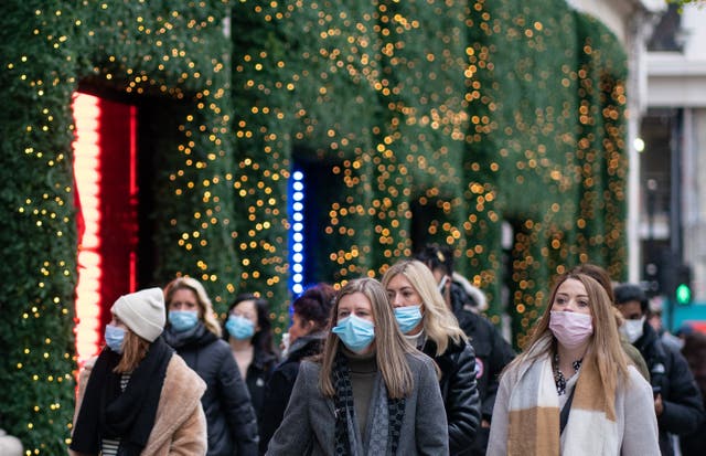Shoppers wearing face masks while walking down a high street