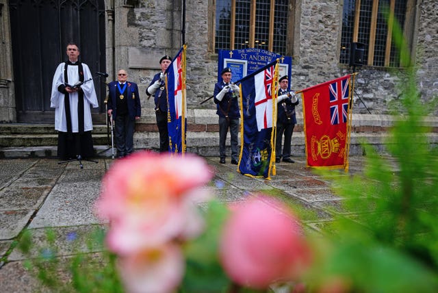People observe a two-minute silence to remember the war dead on Armistice Day at St Andrew’s church in Plymouth, Devon