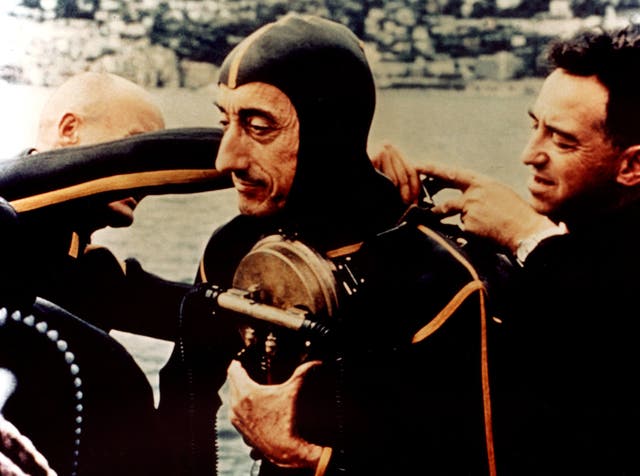 Jacques Cousteau putting his gear on