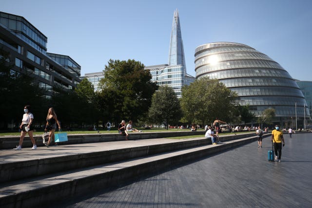 Lunch-time visitors observe social distancing rules as they enjoy the autumn sunshine in Potters Field Park, near City Hall, London