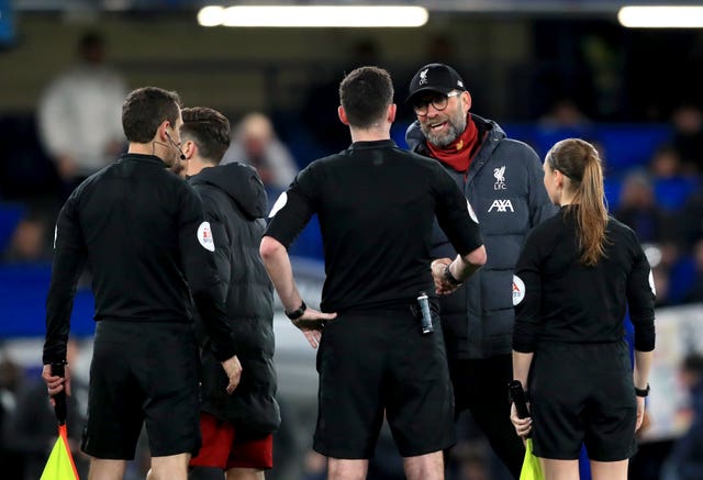 Jurgen Klopp, second right, speaks to referee Chris Kavanagh, centre, at full-time