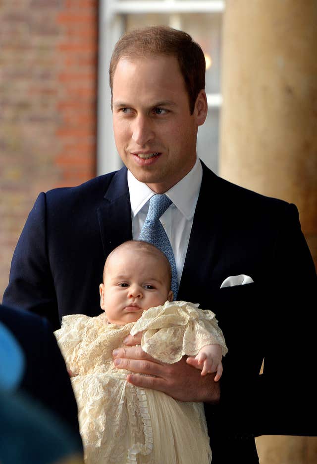 The Duke of Cambridge arrives, holding his son Prince George, at Chapel Royal in St James’s Palace, ahead of the christening (John Stillwell/PA)