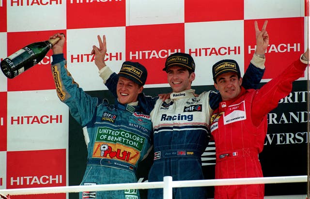 Britain's Damon Hill, centre, poses on the podium alongside championship leader Michael Schumacher, left, and race runner-up Jean Alesi, right, in 1994. Hill followed in the footsteps of father, Graham, by driving to victory at Silverstone, doing so in his Williams Renault