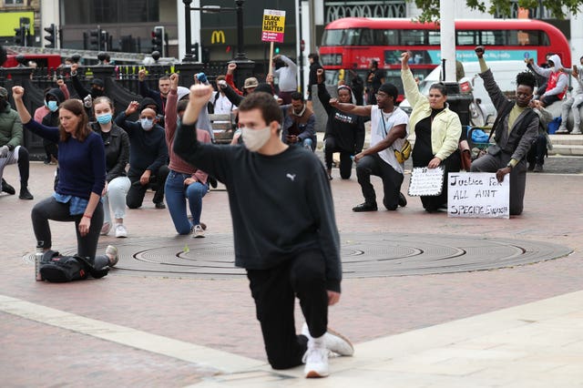 People take a knee during a Black Lives Matter protest