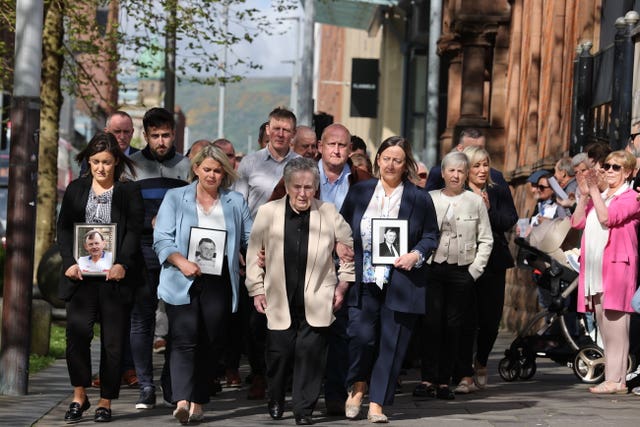 Supporters of the family of GAA official Sean Brown applaud as they arrive at court